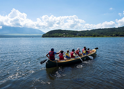 Friendship Camp for Mothers and Children: Crossing a lake in a large cano